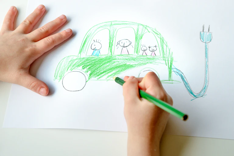 A child drawing an electric car