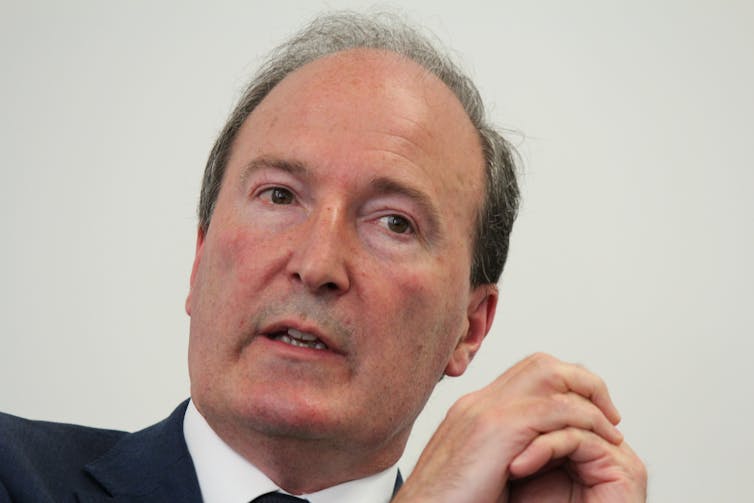 Headshot of middle-aged man in a suit.