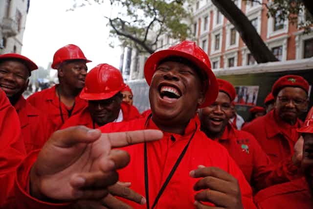 Julius Malema, leader of South Africa's Economic Freedom Fighters, and members of his party outside parliament.