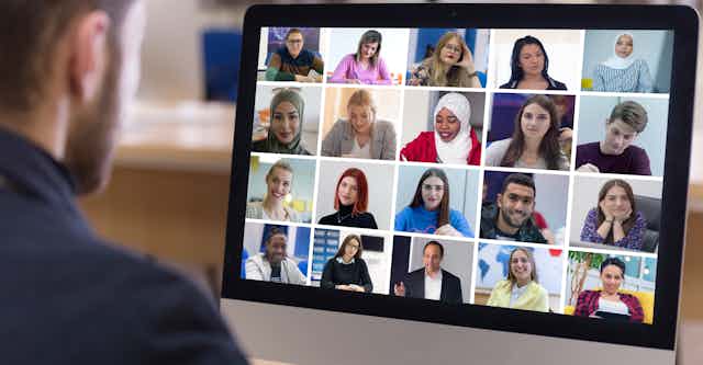 A videoconferencing screen with many faces.