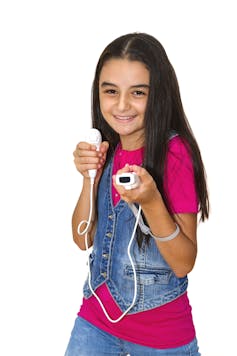 A young teenager in a pink t-shirt and denim waistcoat holding a Wii controller.