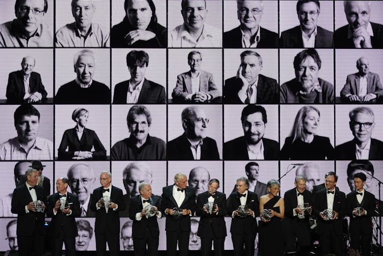 people on stage holding awards