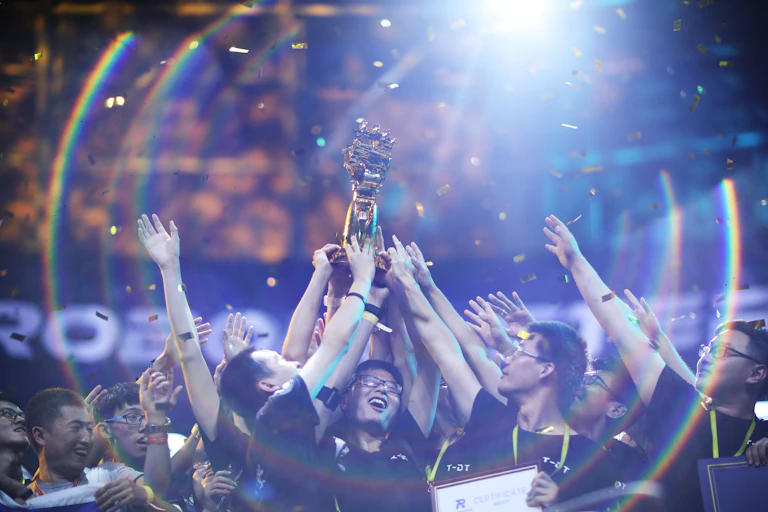 students celebrate holding prize aloft