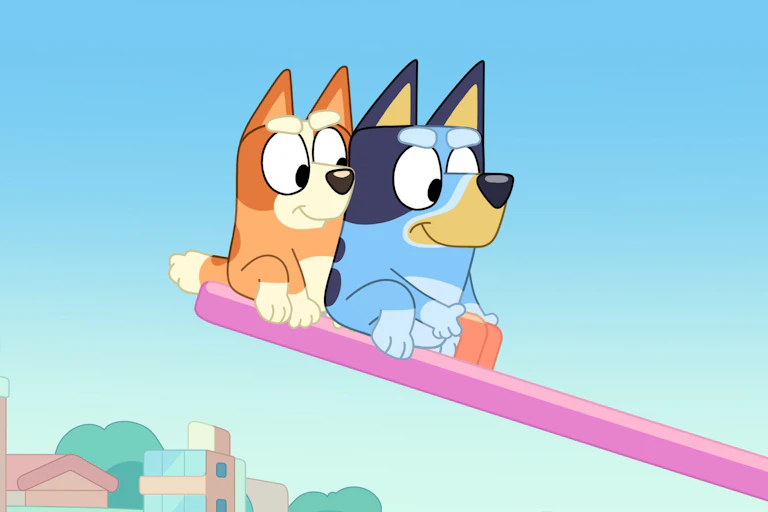 Cartoon dogs look down seesaw/slide