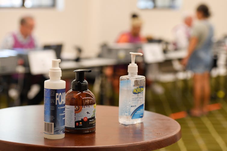 Hand sanitisers on a table at a polling booth.