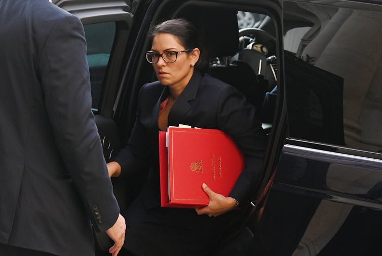 Priti Patel getting out of a car.