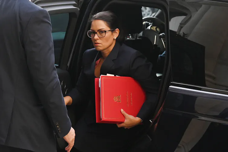 Priti Patel getting out of a car.