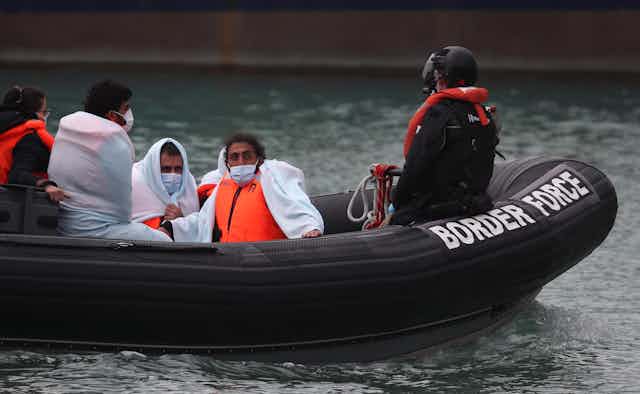 A Border Force boat brings people ashore in Kent. 