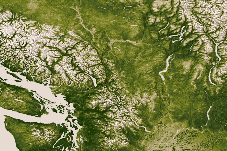 A satellite photo of the Pacific Northwest showing near continuous green coverage.