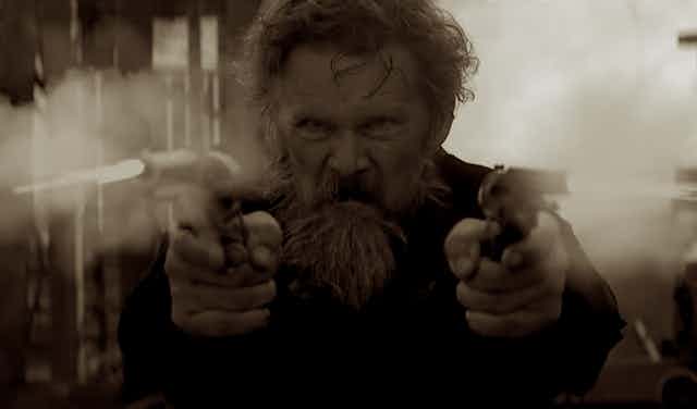 John Brown fires two pistols in a scene from the TV miniseries.