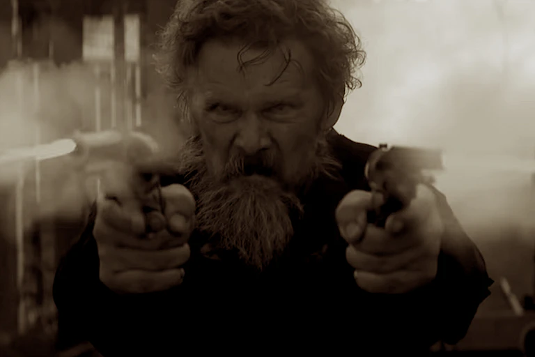 John Brown fires two pistols in a scene from the TV miniseries.