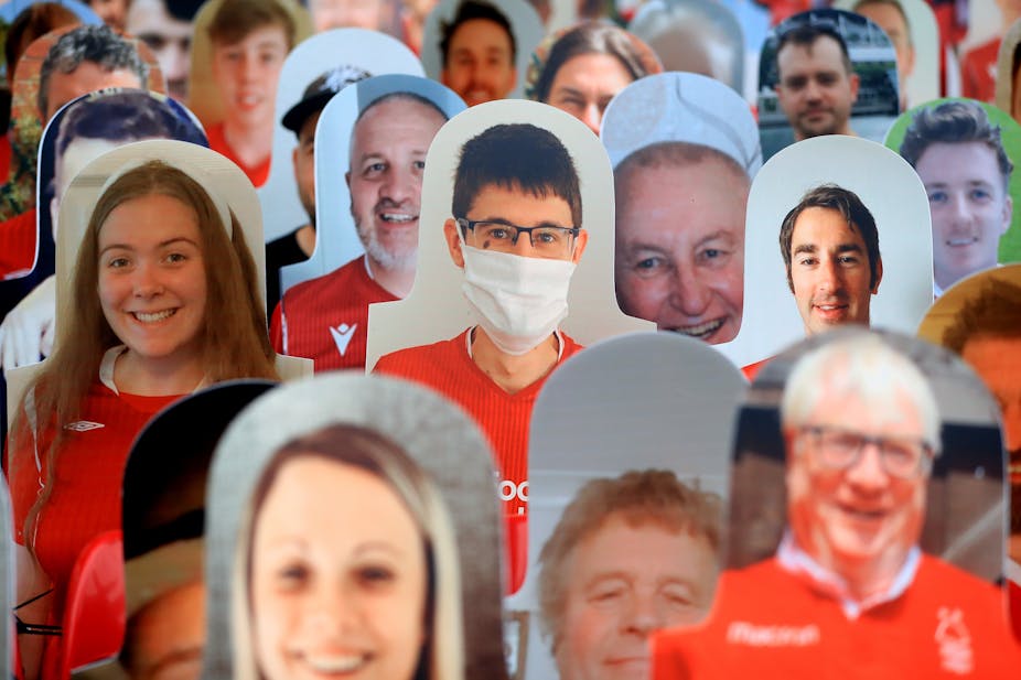 Lots of cardboard cut-outs of football fans