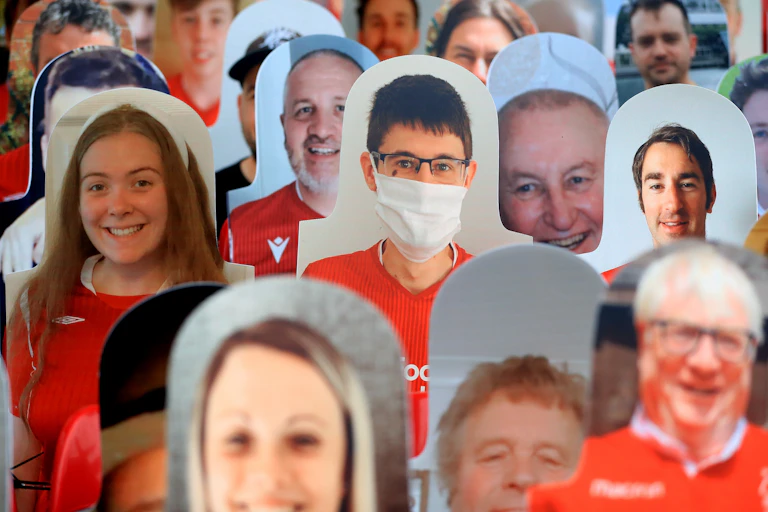 Lots of cardboard cut-outs of football fans