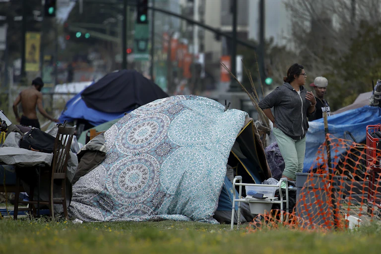 People at a tent encampment.