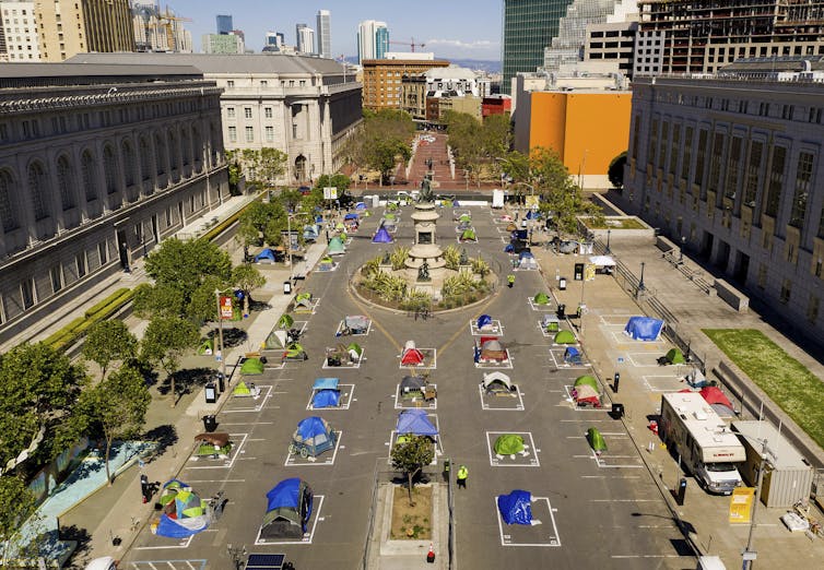 Rows of tents in squares to keep them apart.