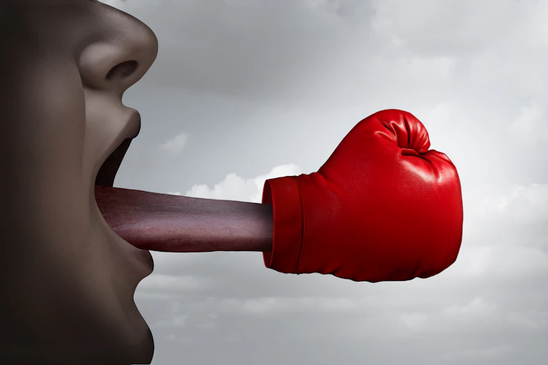 A tongue with a fist coming out of a mouth