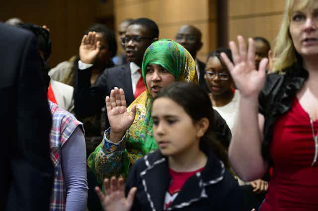 New Canadians take the Oath of Citizenship on Parliament Hill in Ottawa. 