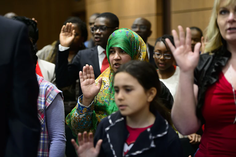 New Canadians take the Oath of Citizenship on Parliament Hill in Ottawa.