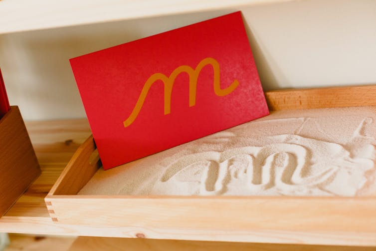 Montessori-style sandpaper letter 'M'