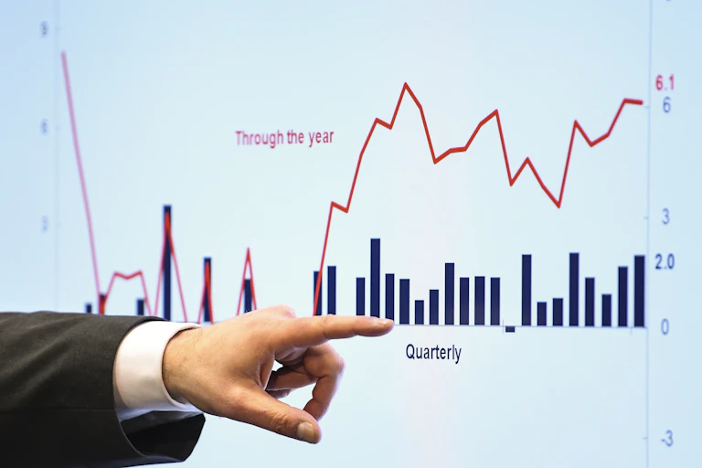 A hand pointing at a graph