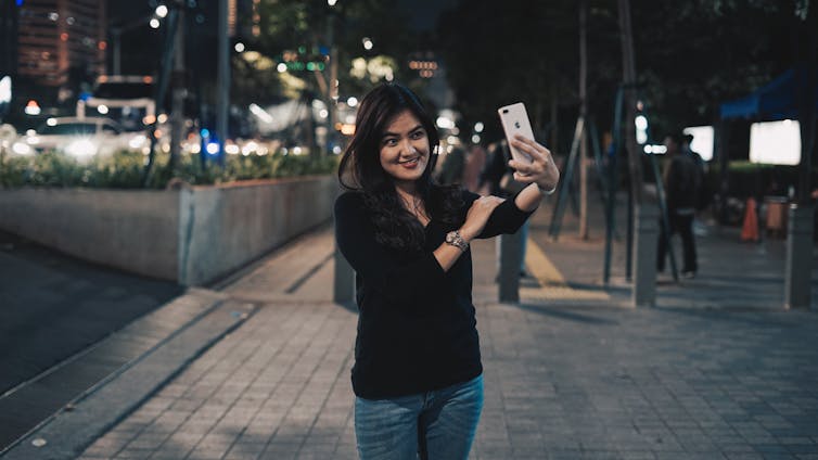 Girl takes selfie on street