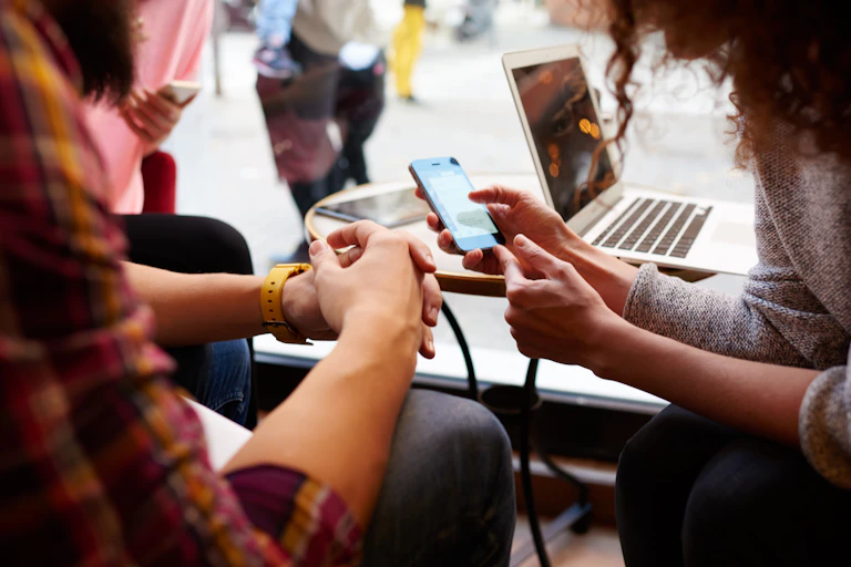 Two people looking at a smartphone.