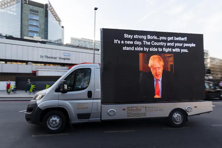 Billboard on a van with a photo of Boris Johnson drive past St Thomas's hospital