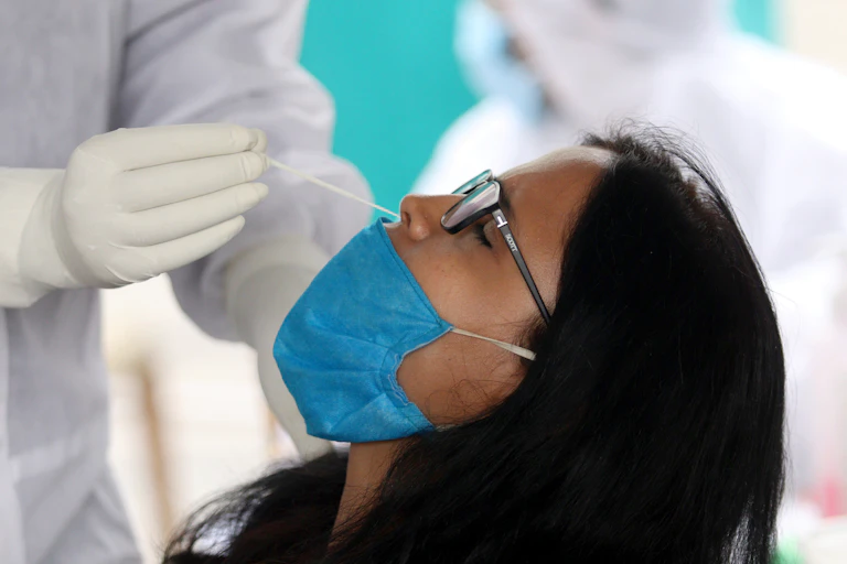 A woman having her nose swabbed to test for COVID