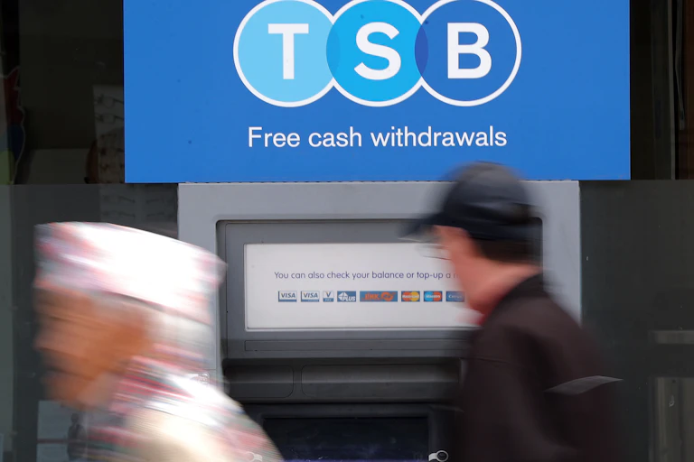 Two people outside a TSB ATM