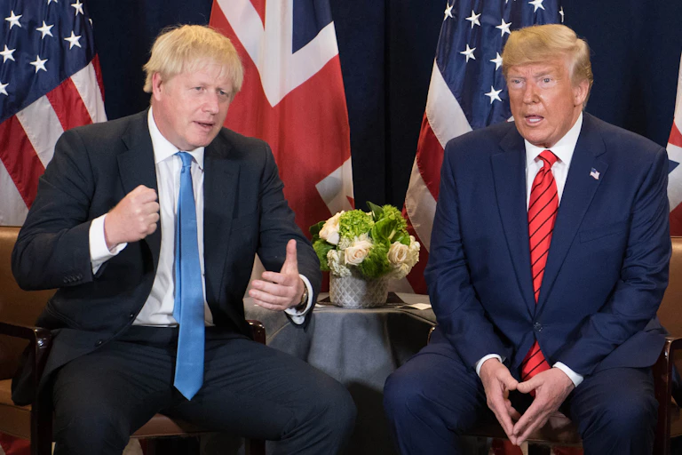 Boris Johnson and Donald Trump sitting with UK and US flags behind.