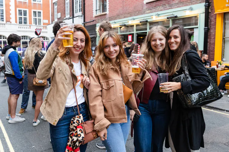 A group of women socialising on a street in London