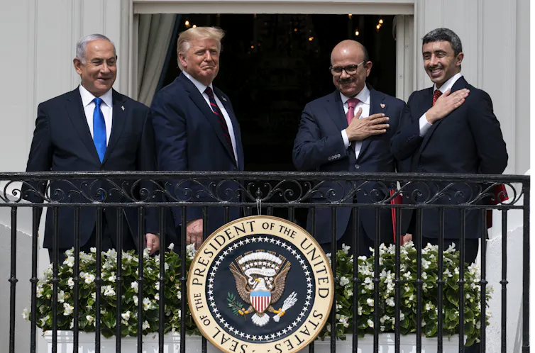 Israeli Prime Minister Benjamin Netanyahu, left, President Donald Trump, Bahrain Foreign Minister Khalid bin Ahmed Al Khalifa and United Arab Emirates Foreign Minister Abdullah bin Zayed al-Nahyan stand together on a balcony.