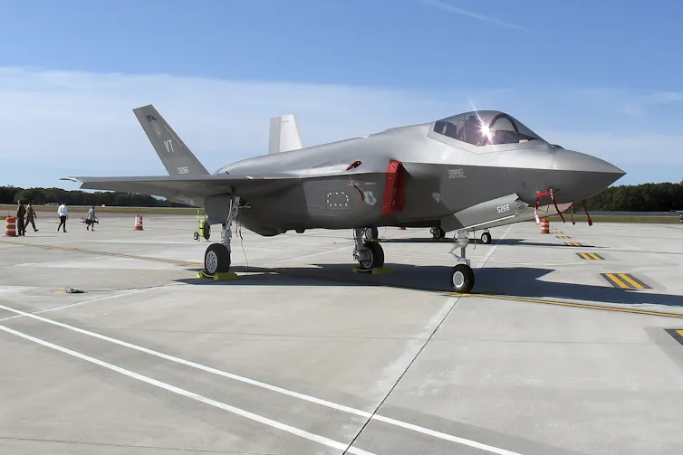 A fighter jet sits on a tarmac.