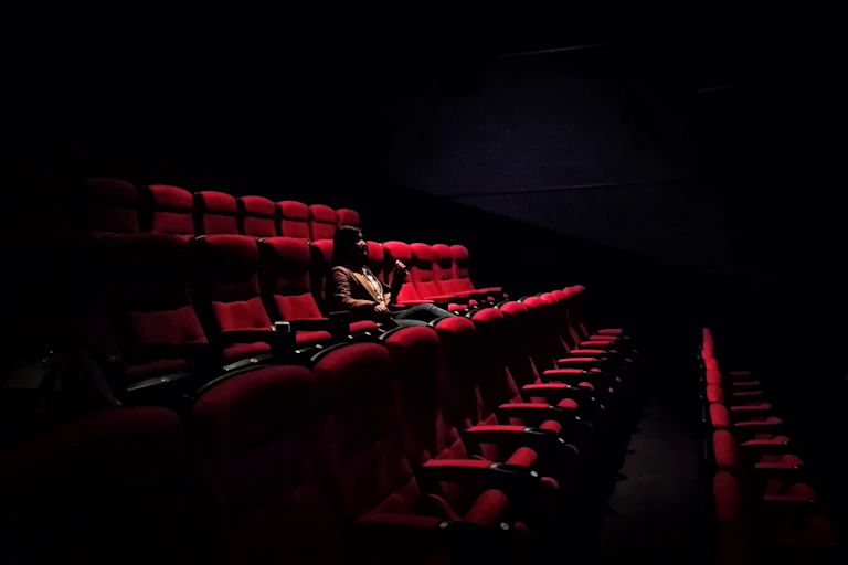 One woman sits in empty theatre