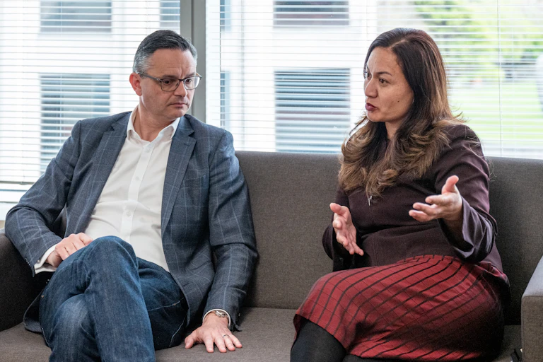 man and woman on sofa talking