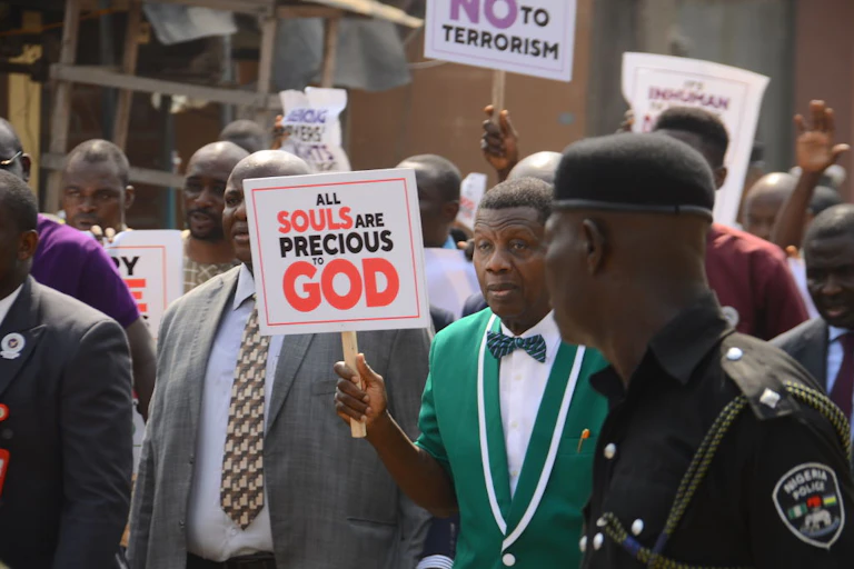 Men walking in the street holding placards