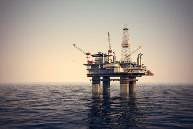 Faded image of oil rig in ocean