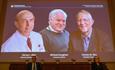 three scientist projected on screen at announcement