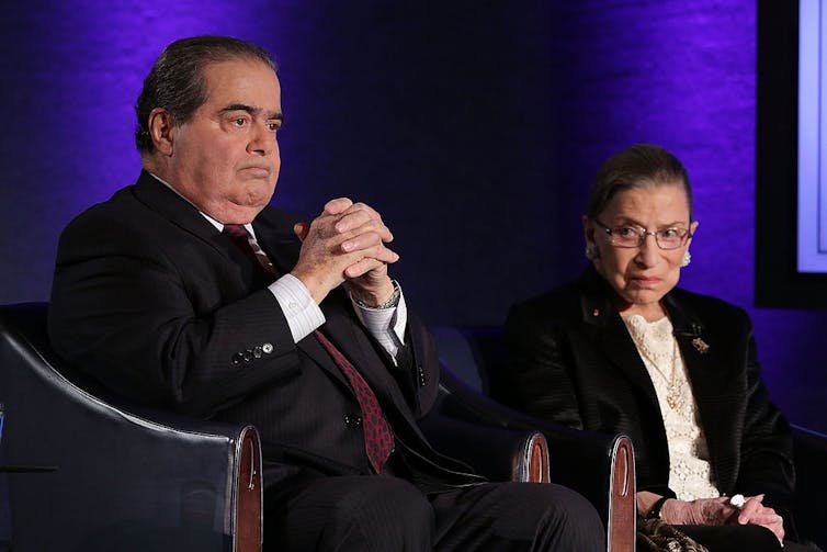 Scalia sits next to Ginsburg at the National Press Club in 2014.