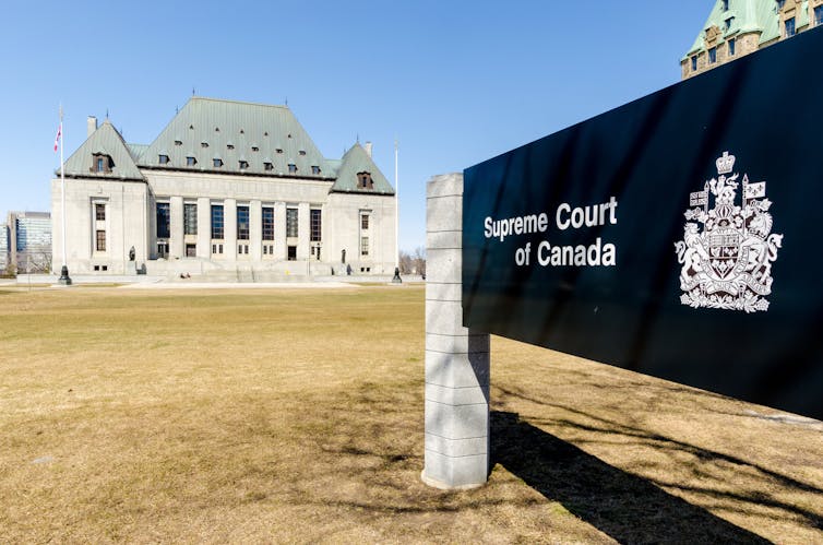The Supreme Court of Canada in the background and signage in the foreground