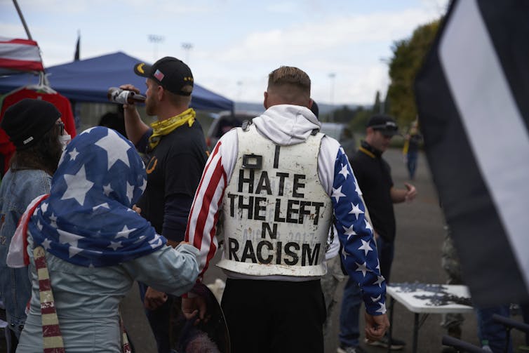 A man wears an 'I Hate the Left' protective vest at a Proud Boys rally in Delta Park, in Portland, Oregon, US