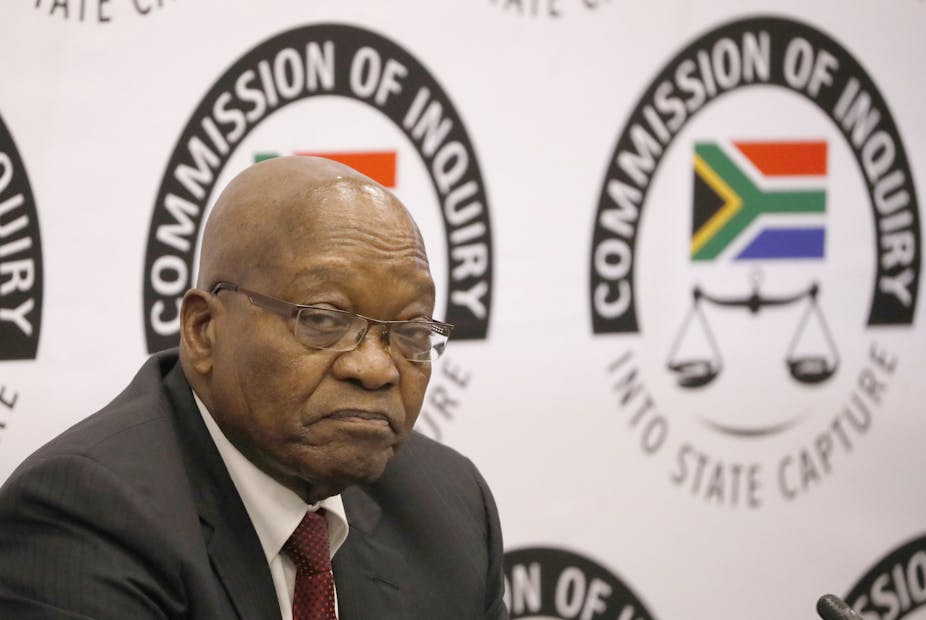 Jacob Zuma in front of Commission of Inquiry logo at the inquiry venue