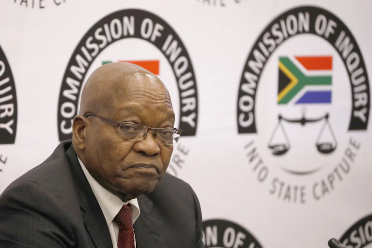 Jacob Zuma in front of Commission of Inquiry logo at the inquiry venue