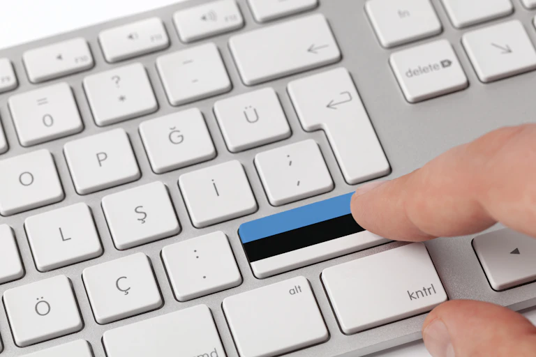 Pressing a key on a keyboard with Estonian flag.