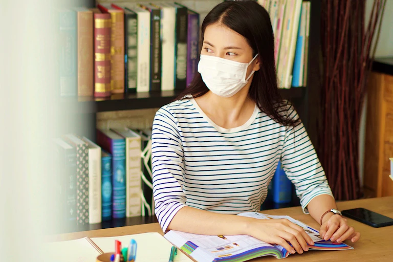 Woman in library wearing mask