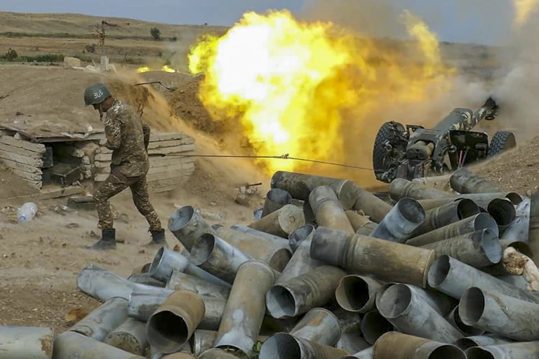 Soldier next to gun and fire ball.
