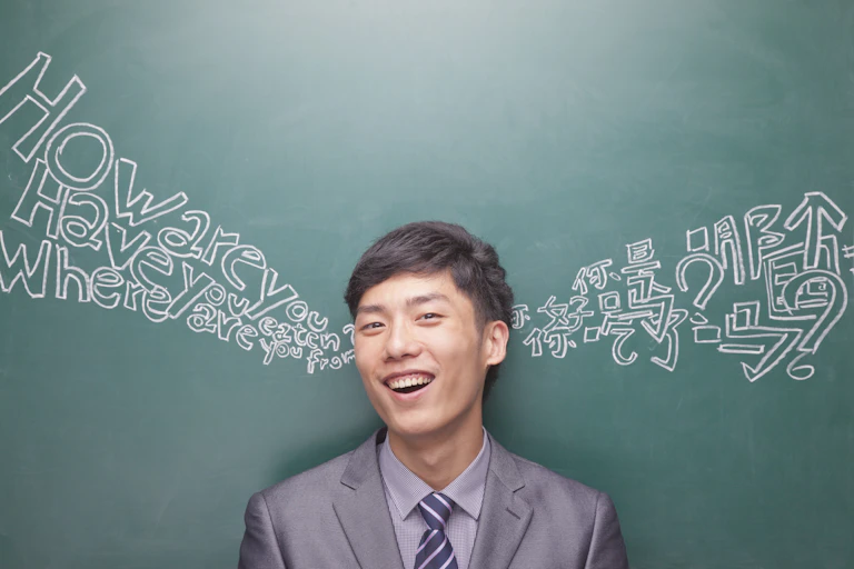 Ban in front of chalkboard with English and Chinese writing