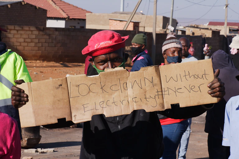 Protesters holding up signs