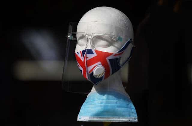 A union jack mask displayed on a styrofoam model of a head. 