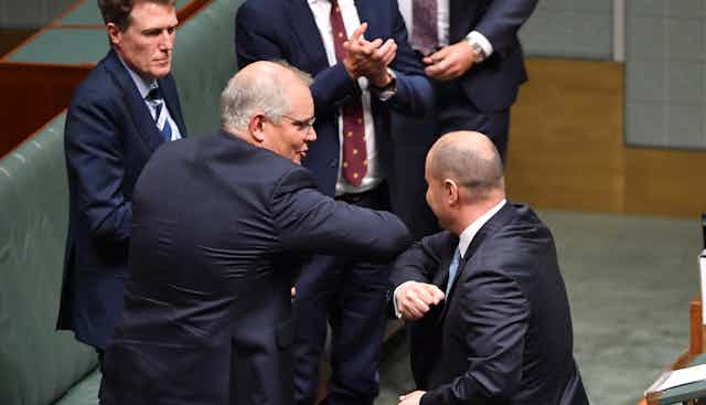 Scott Morrison and Josh Frydenberg elbow-bump in parliament